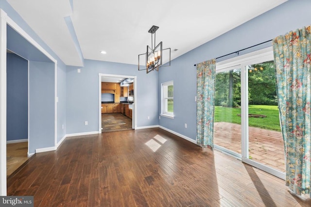  - spare room featuring hardwood / wood-style floors, a chandelier, and recessed lighting