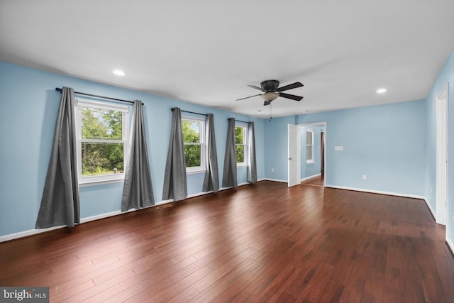  - unfurnished room with a ceiling fan, healthy amount of natural light, wood finished floors, and recessed lighting