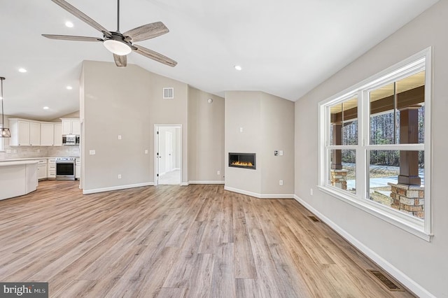 unfurnished living room with baseboards, ceiling fan, light wood-style floors, and visible vents