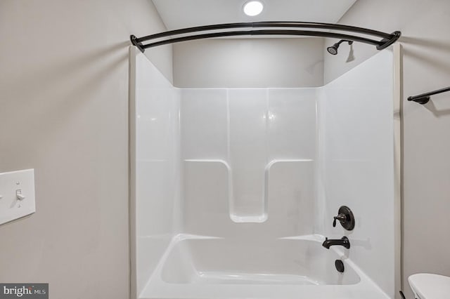 bathroom featuring toilet and a shower