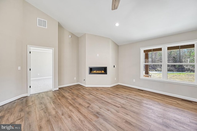 unfurnished living room with light wood-style floors, visible vents, and baseboards