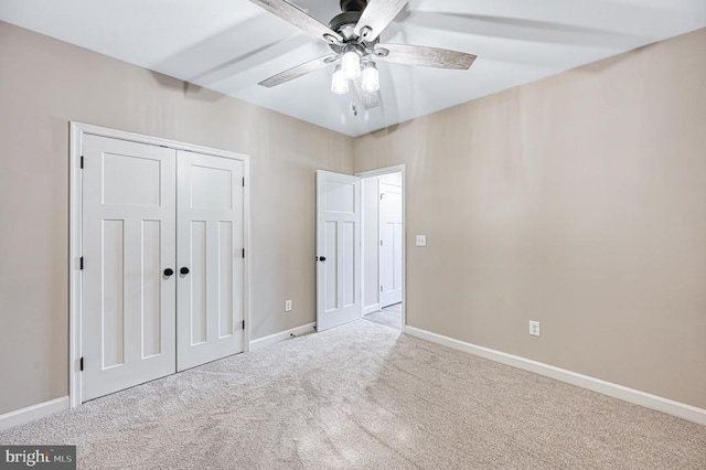 unfurnished bedroom featuring baseboards, carpet flooring, a closet, and a ceiling fan