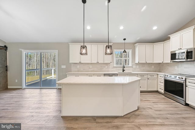 kitchen with vaulted ceiling, decorative backsplash, stainless steel appliances, and a sink