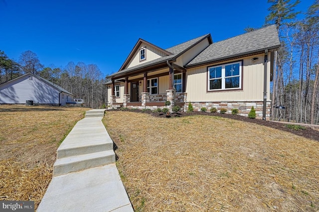 view of front of house with roof with shingles and covered porch