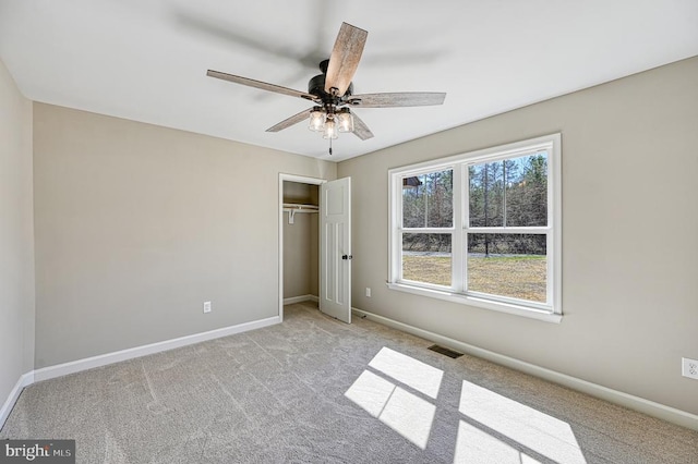 unfurnished bedroom with carpet, baseboards, a closet, and visible vents