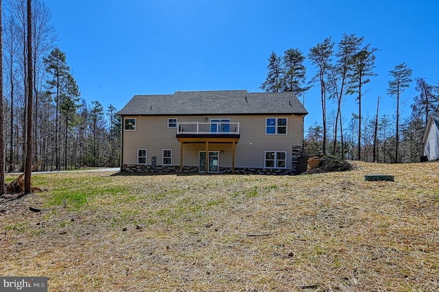 rear view of house with a yard and a deck