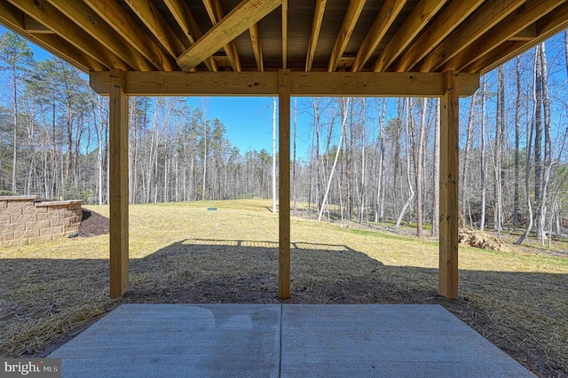 view of patio with a wooded view