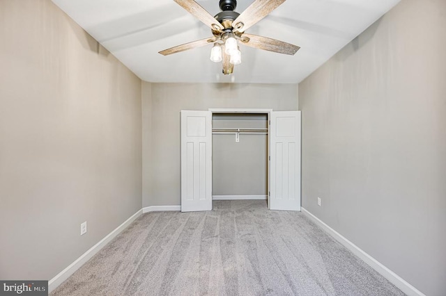 unfurnished bedroom featuring carpet, a closet, baseboards, and a ceiling fan