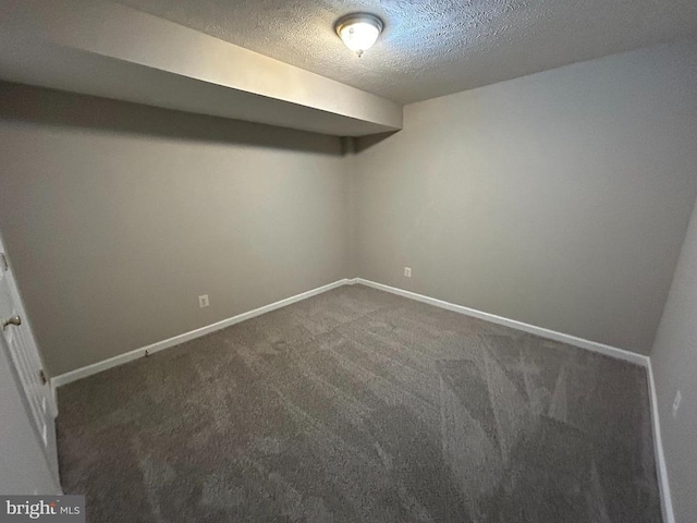 4213 Normandy Ct, Fredericksburg, VA 22408 - finished below grade area featuring a textured ceiling, dark carpet, and baseboards