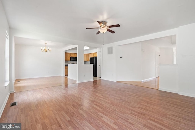 12303 Osprey Ln, Culpeper, VA 22701 - unfurnished living room with a chandelier, ceiling fan, light wood-style floors, and baseboards