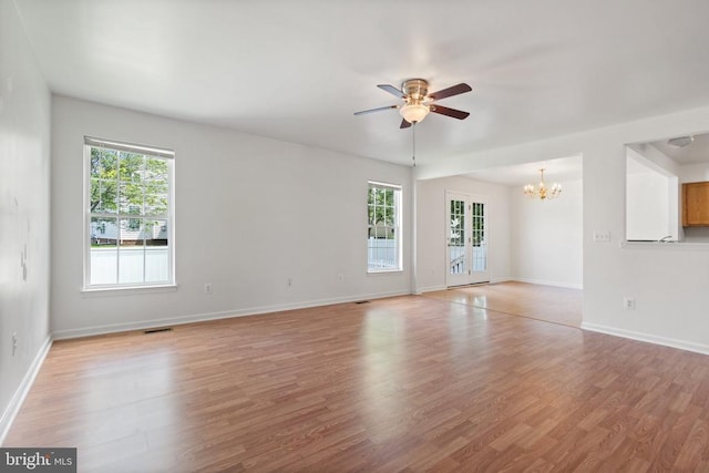12303 Osprey Ln, Culpeper, VA 22701 - unfurnished room featuring a chandelier, ceiling fan, light wood-style flooring, and baseboards