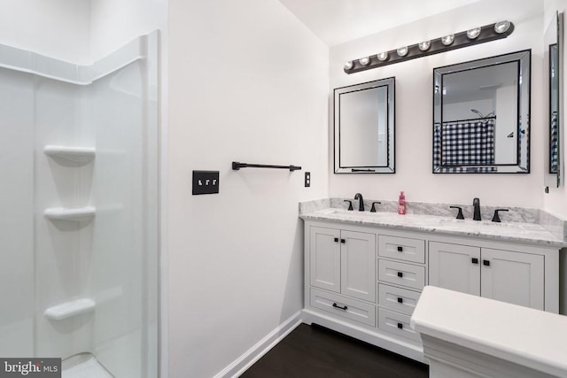12303 Osprey Ln, Culpeper, VA 22701 - bathroom featuring double vanity, a shower with curtain, wood finished floors, and baseboards