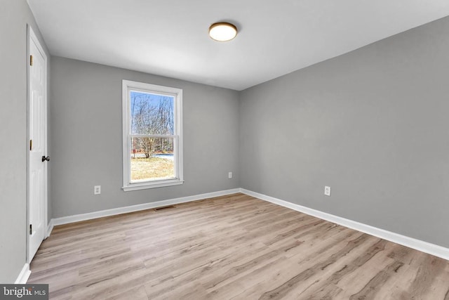 unfurnished bedroom with baseboards, visible vents, and light wood finished floors