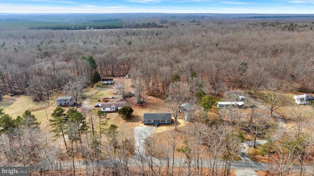 birds eye view of property with a wooded view