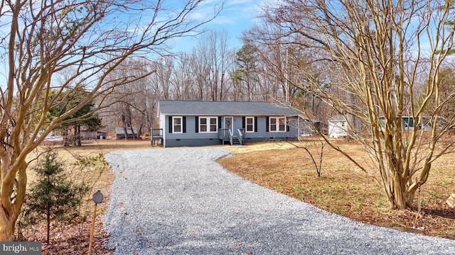 single story home with crawl space and gravel driveway