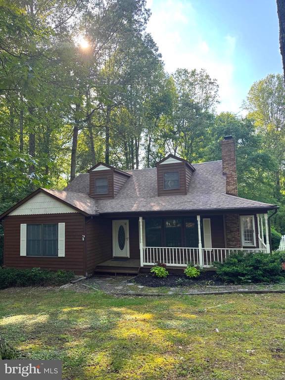 12704 Getty Ln, Spotsylvania, VA 22551 - view of front of house featuring a porch, a front yard, a chimney, and a shingled roof