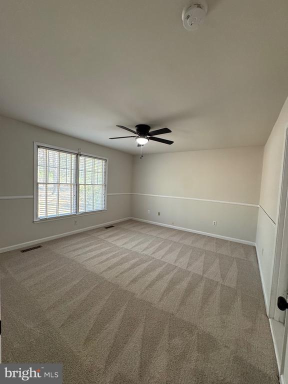 12704 Getty Ln, Spotsylvania, VA 22551 - spare room with a ceiling fan, light carpet, and a smoke detector