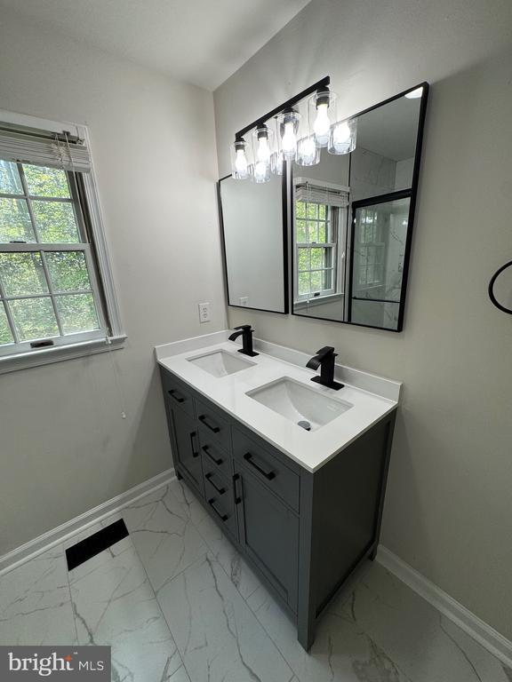 12704 Getty Ln, Spotsylvania, VA 22551 - bathroom with marble finish flooring, double vanity, and a shower