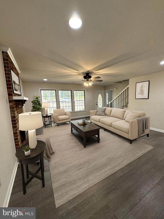 12704 Getty Ln, Spotsylvania, VA 22551 - living area featuring a ceiling fan, recessed lighting, wood finished floors, stairway, and a brick fireplace