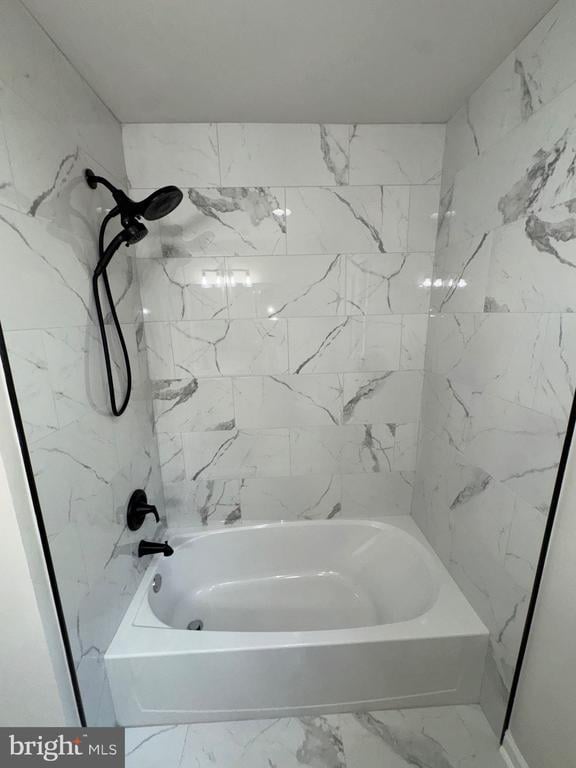 12704 Getty Ln, Spotsylvania, VA 22551 - bathroom featuring marble look tiles and shower / tub combination