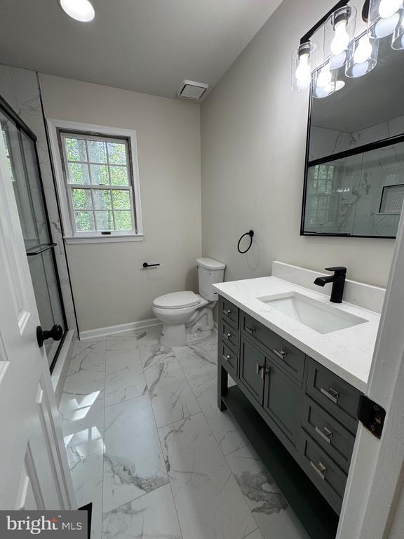 12704 Getty Ln, Spotsylvania, VA 22551 - full bathroom with marble finish floors, vanity, and a marble finish shower