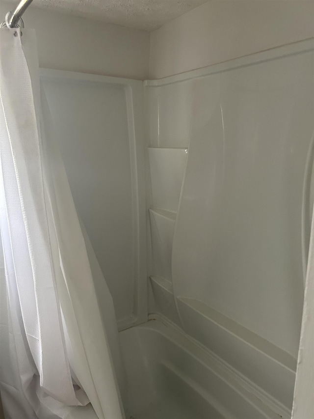125 Mccutchen School Ln, Goshen, VA 24439 - bathroom with shower / bath combo and a textured ceiling