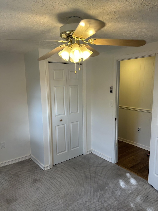 125 Mccutchen School Ln, Goshen, VA 24439 - unfurnished bedroom featuring carpet floors, a closet, a textured ceiling, and a ceiling fan