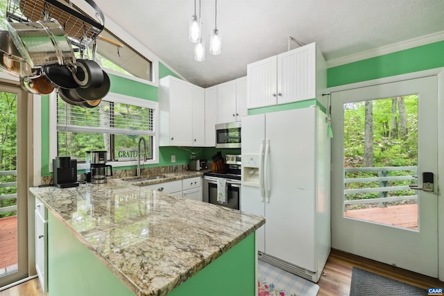134 Gumtree Dr, Wintergreen Resort, VA 22967 - kitchen with stainless steel appliances, a sink, a peninsula, white cabinetry, and light stone counters
