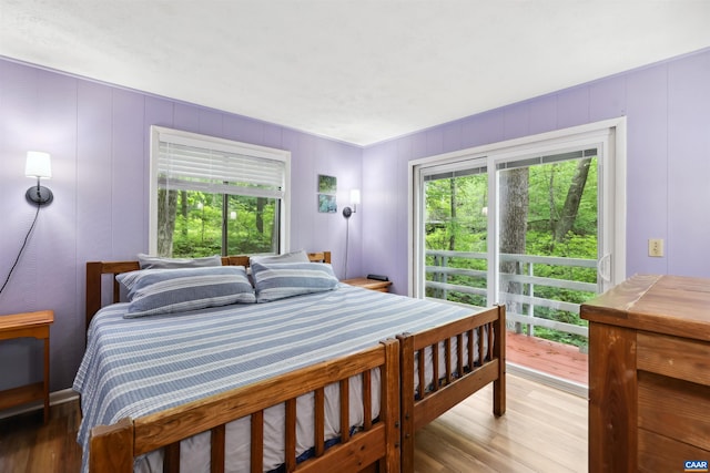 134 Gumtree Dr, Wintergreen Resort, VA 22967 - bedroom with wood finished floors, multiple windows, and a decorative wall