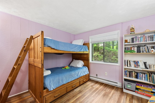 134 Gumtree Dr, Wintergreen Resort, VA 22967 - bedroom with a baseboard heating unit and wood finished floors