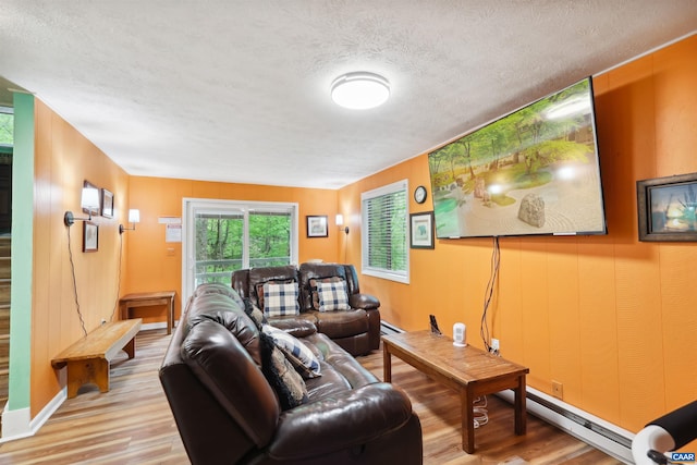 134 Gumtree Dr, Wintergreen Resort, VA 22967 - living area featuring wood finished floors, a textured ceiling, and a baseboard radiator