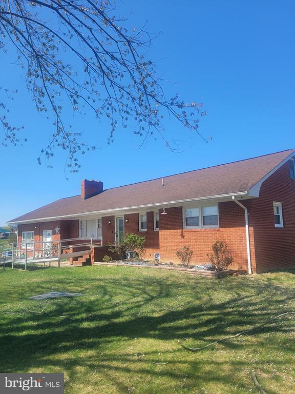 1441 Aylor Grubbs Ave, Stanley, VA 22851 - ranch-style house featuring a chimney, brick siding, and a front lawn