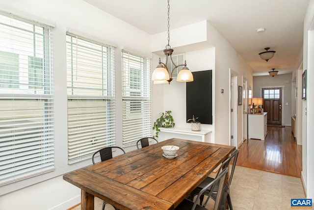 814 Cole St, Charlottesville, VA 22901 - dining space with light tile patterned flooring, baseboards, and a chandelier