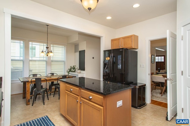 814 Cole St, Charlottesville, VA 22901 - kitchen with a center island, dark stone countertops, hanging light fixtures, black fridge, and recessed lighting