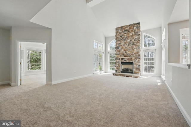 11402 Chivalry Chase Ln, Spotsylvania, VA 22551 - unfurnished living room featuring carpet floors, a towering ceiling, healthy amount of natural light, a fireplace, and baseboards