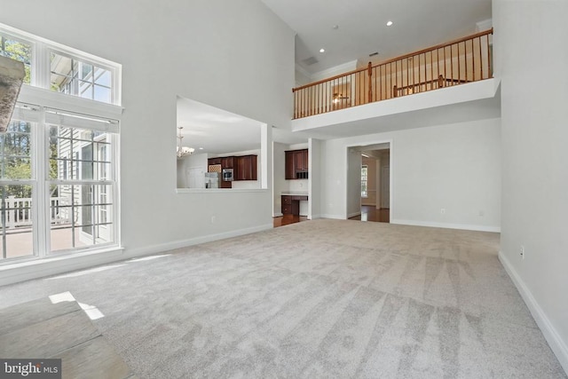 11402 Chivalry Chase Ln, Spotsylvania, VA 22551 - unfurnished living room with a high ceiling, carpet, a chandelier, and baseboards