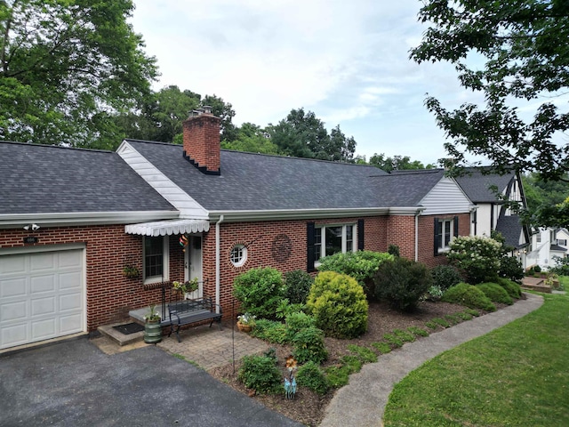 406 College Cir, Staunton, VA 24401 - view of front facade featuring roof with shingles, a chimney, brick siding, and a garage