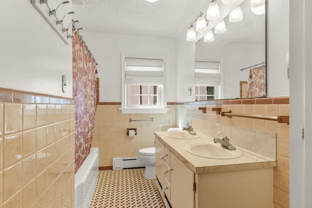 406 College Cir, Staunton, VA 24401 - full bath featuring a baseboard radiator, tile walls, wainscoting, double vanity, and shower / bath combo