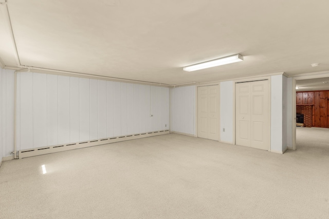 406 College Cir, Staunton, VA 24401 - finished below grade area featuring a baseboard heating unit, a brick fireplace, light colored carpet, and wood walls