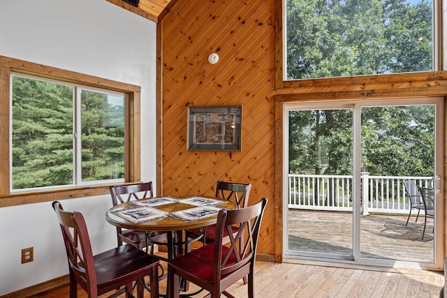 1215 Fort Stover Rd, Luray, VA 22835 - dining room with wood walls, plenty of natural light, wood-type flooring, and a high ceiling