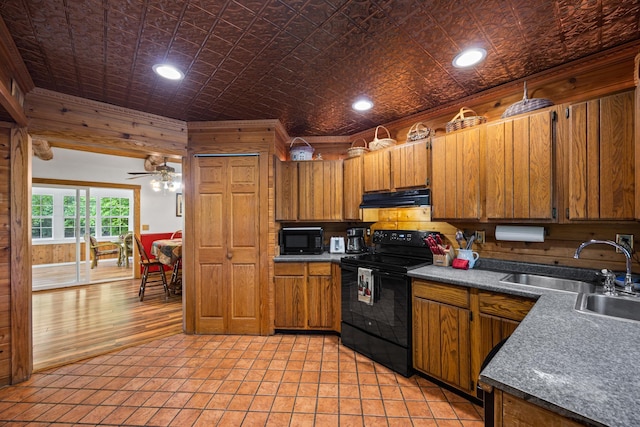 1215 Fort Stover Rd, Luray, VA 22835 - kitchen with black appliances, under cabinet range hood, an ornate ceiling, brown cabinets, and a ceiling fan