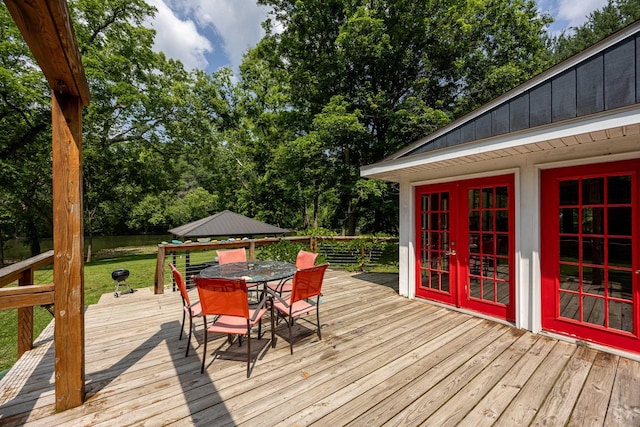 1215 Fort Stover Rd, Luray, VA 22835 - wooden deck with outdoor dining space and view of wooded area