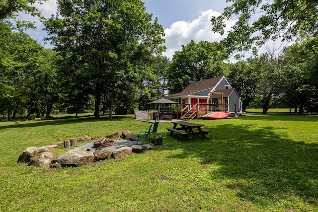 1215 Fort Stover Rd, Luray, VA 22835 - view of green lawn with a fire pit, a wooden deck, and view of scattered trees