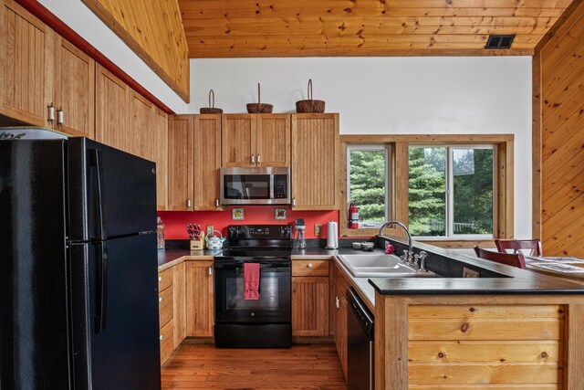 1215 Fort Stover Rd, Luray, VA 22835 - kitchen featuring black appliances, wooden ceiling, wood finished floors, dark countertops, and wooden walls