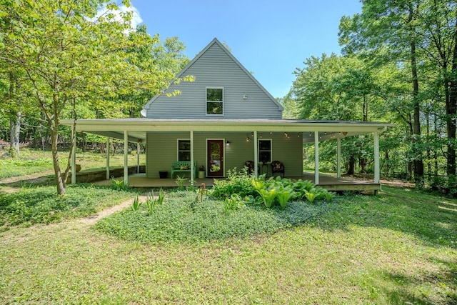 rear view of property featuring a lawn