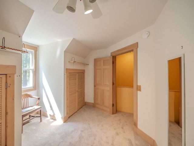 additional living space featuring ceiling fan and light carpet