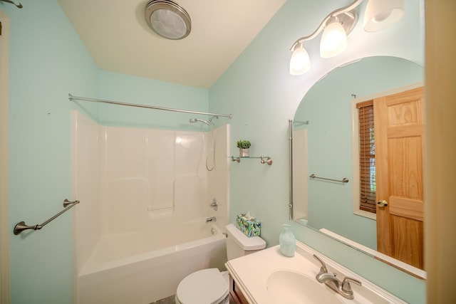 bathroom featuring toilet, vanity, and tub / shower combination