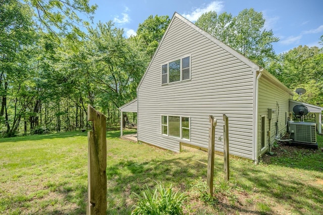 view of home's exterior with central AC and a lawn
