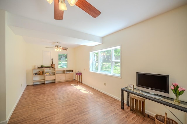 living room with wood finished floors, ceiling fan, and baseboards