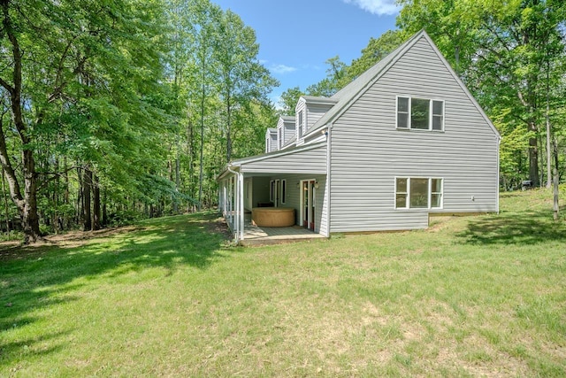 back of property with a lawn